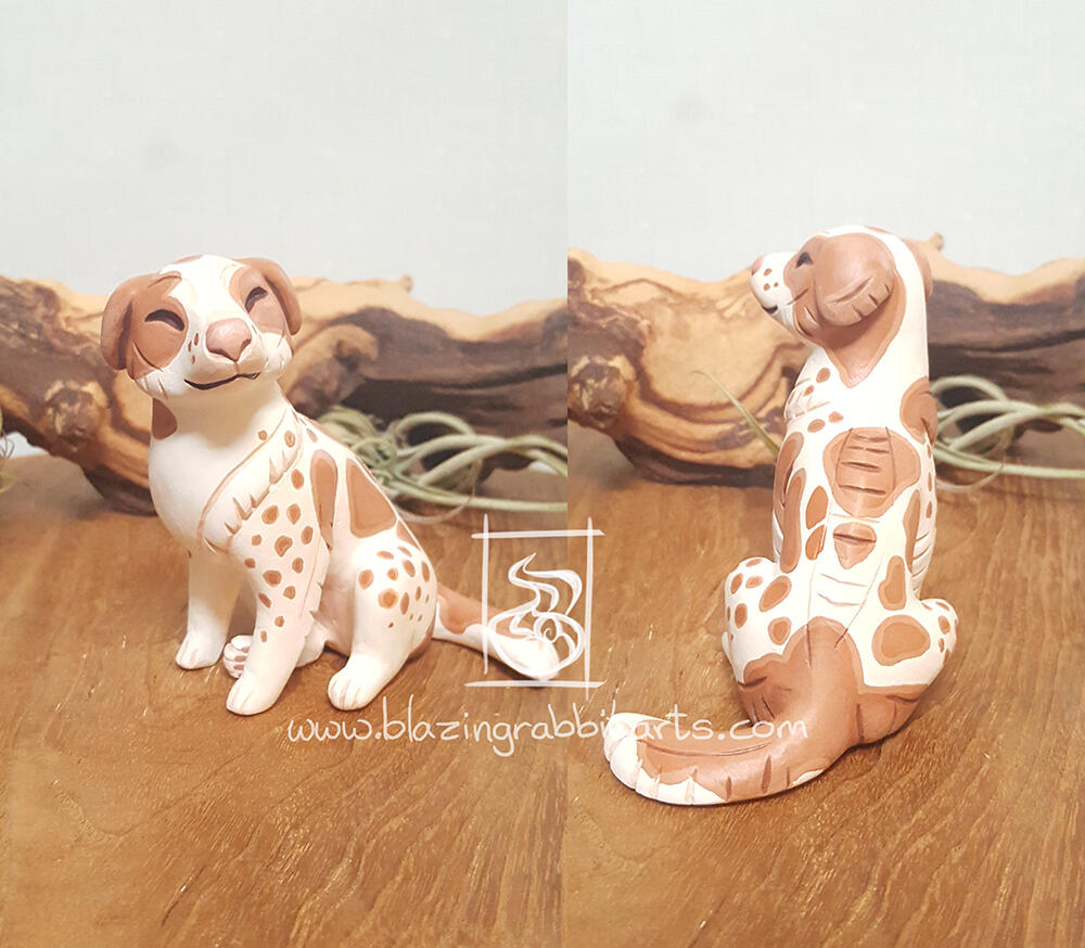 Filou Sculpture of a dog sitting.