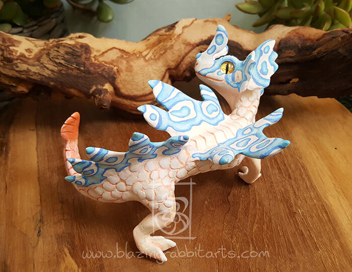 River Dragon Sculpture of a pink and blue river dragon.