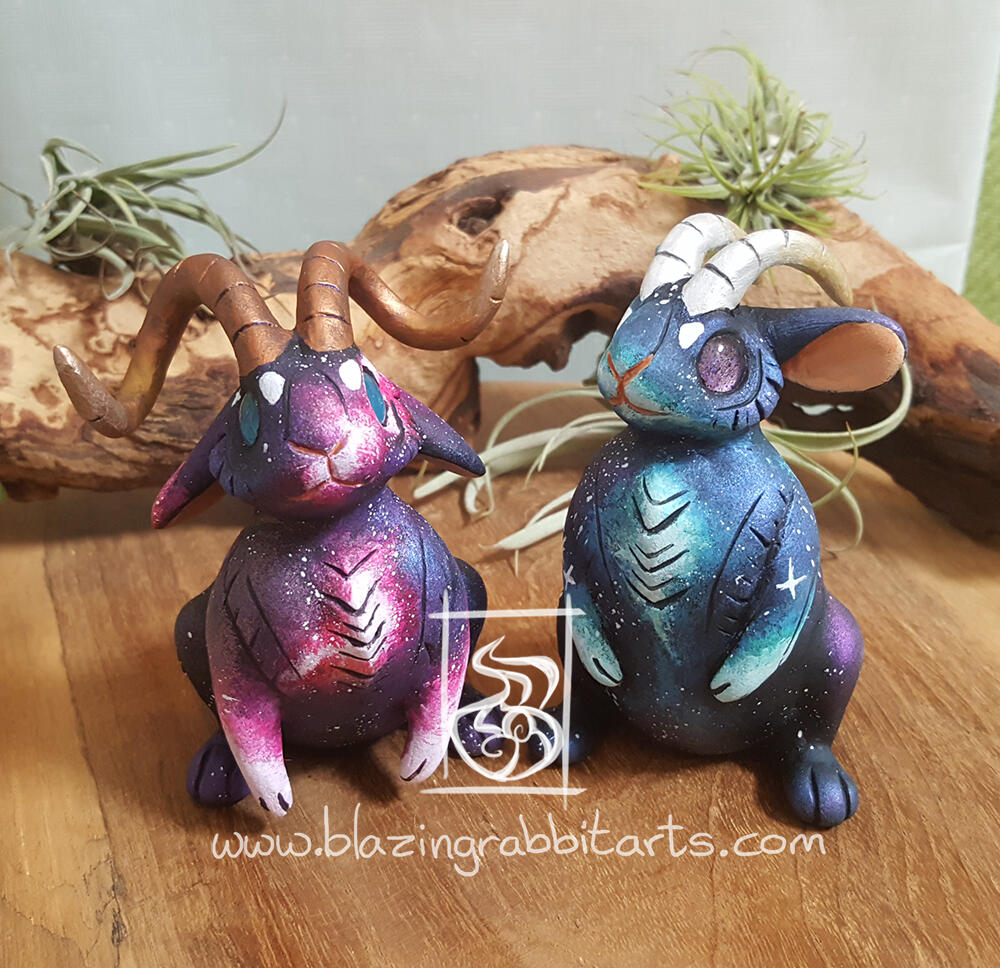 Galaxy Jackalopes Sculptures of a pink and blue galaxy Jackalope.
